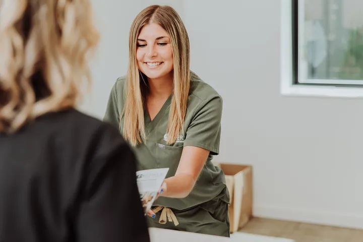 A patient care coordinator going over paperwork with a patient